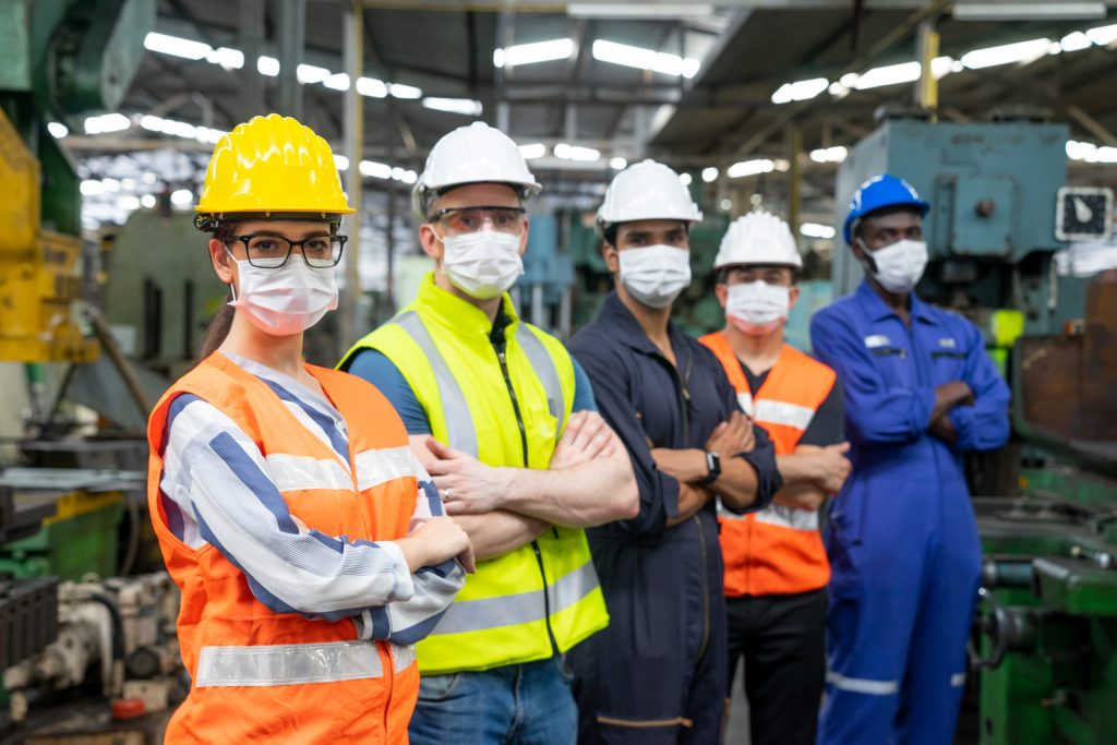 Equipo de trabajadores de fábrica siderúrgica posando para foto